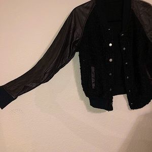 A fitted, kinda cropped, half leather/wool jacket